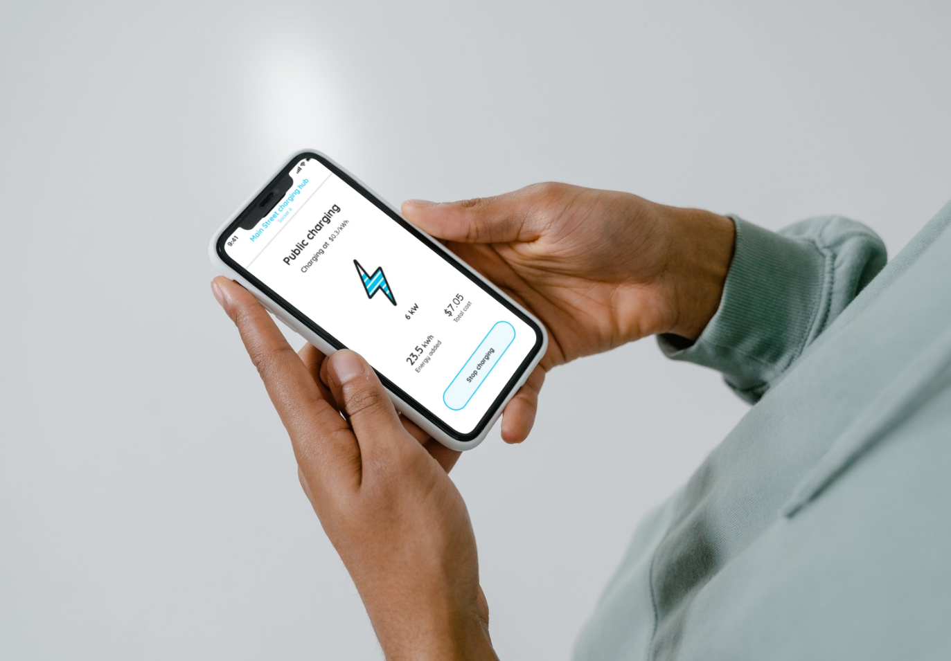 man holding a phone looking at ev charging app notification
